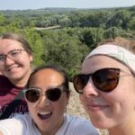 Mentors taking a selfie over the overlook in Saint Paul